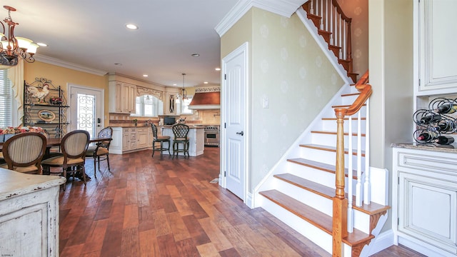 interior space with ornamental molding, hardwood / wood-style floors, and a chandelier