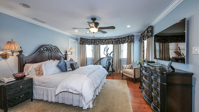 bedroom featuring ceiling fan, ornamental molding, and hardwood / wood-style flooring