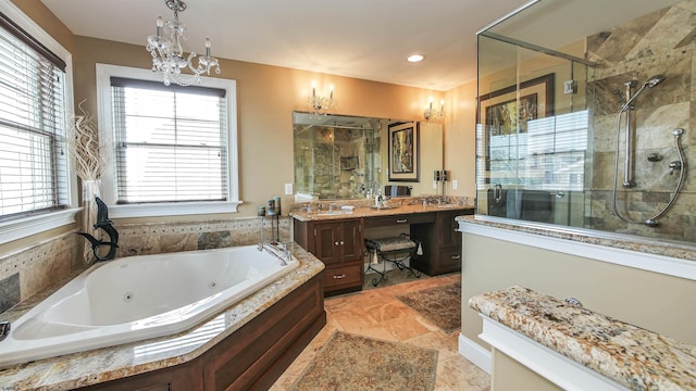 bathroom featuring plus walk in shower, vanity, and tile patterned flooring