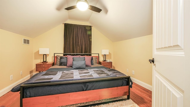 bedroom with ceiling fan, lofted ceiling, and hardwood / wood-style flooring