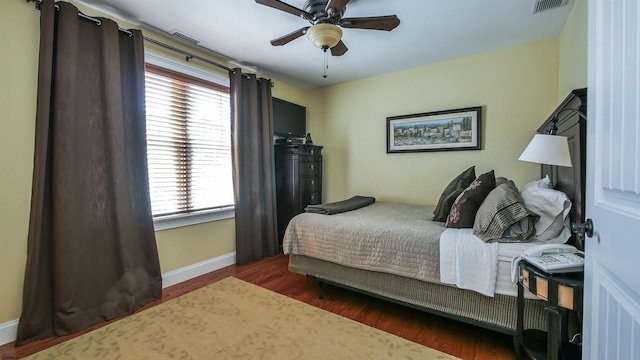 bedroom with ceiling fan and dark hardwood / wood-style floors