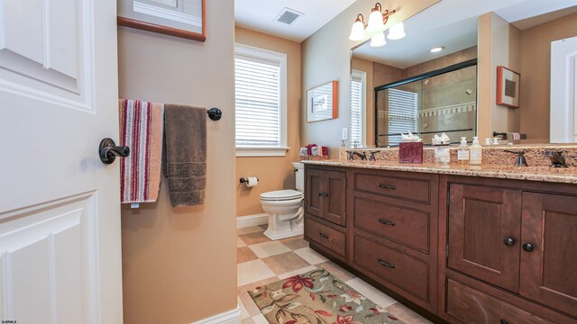 bathroom featuring double sink vanity, toilet, and tile patterned floors