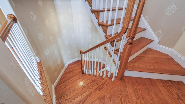 staircase with wood-type flooring