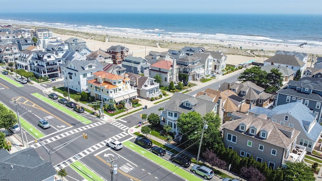 bird's eye view featuring a beach view and a water view