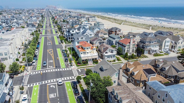 aerial view with a water view and a view of the beach