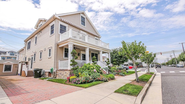 view of front of property with a balcony and covered porch