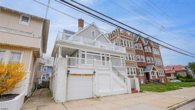 view of property featuring a garage and a balcony