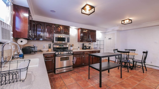 kitchen with tasteful backsplash, stainless steel appliances, light countertops, and ornamental molding