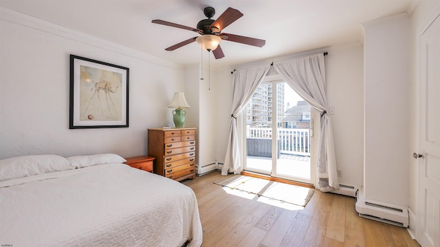 bedroom featuring a baseboard heating unit, access to outside, light wood-style floors, and a ceiling fan