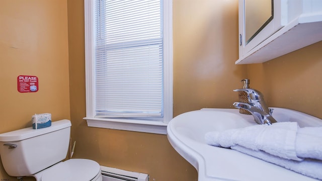 bathroom with baseboard heating and toilet