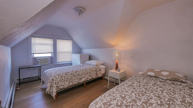 bedroom featuring vaulted ceiling, cooling unit, a baseboard radiator, and wood finished floors