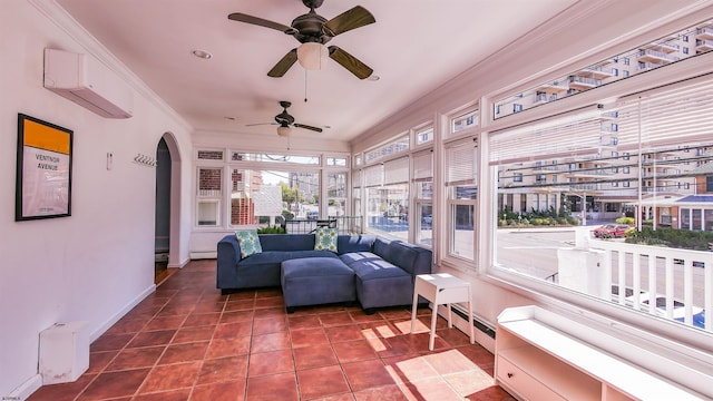 sunroom featuring a baseboard heating unit, an AC wall unit, and arched walkways