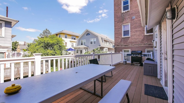 deck featuring a residential view and a grill