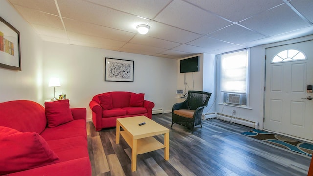 living area with a baseboard heating unit, cooling unit, wood finished floors, and a drop ceiling