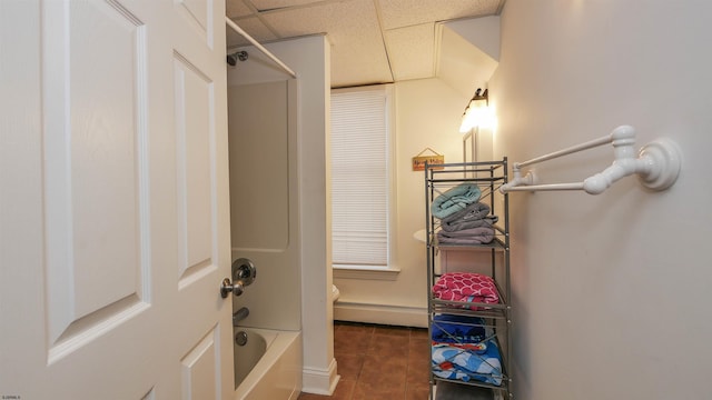 walk in closet featuring tile patterned floors, a drop ceiling, and a baseboard radiator