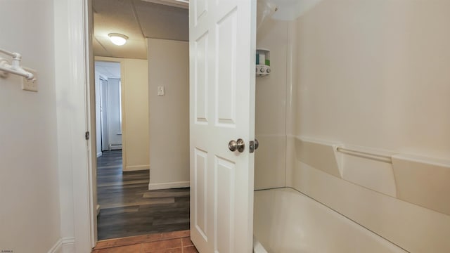 hallway with wood finished floors and baseboards