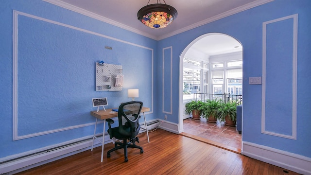 office with hardwood / wood-style floors, baseboards, arched walkways, and ornamental molding