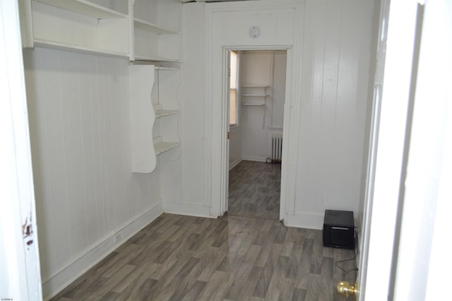 interior space with dark hardwood / wood-style flooring and radiator heating unit