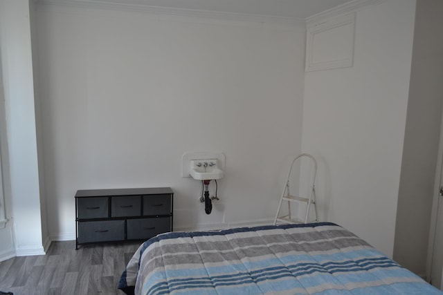 bedroom featuring crown molding and hardwood / wood-style flooring