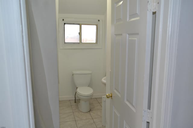 bathroom featuring tile patterned flooring and toilet