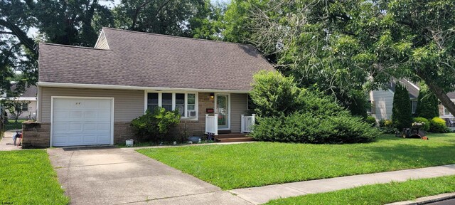 view of front of property with a front lawn and a garage