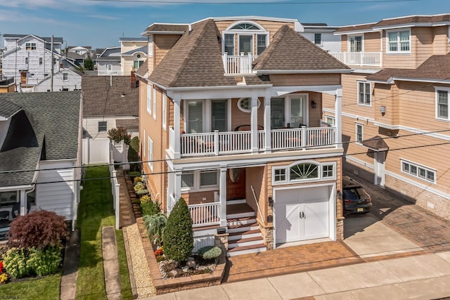 view of front facade featuring a balcony and a garage