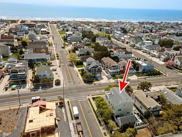 birds eye view of property featuring a water view and a residential view