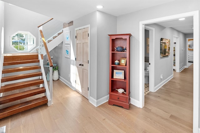 interior space featuring recessed lighting, baseboards, and wood finished floors