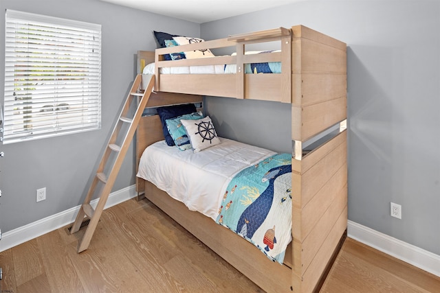 bedroom featuring baseboards and wood finished floors