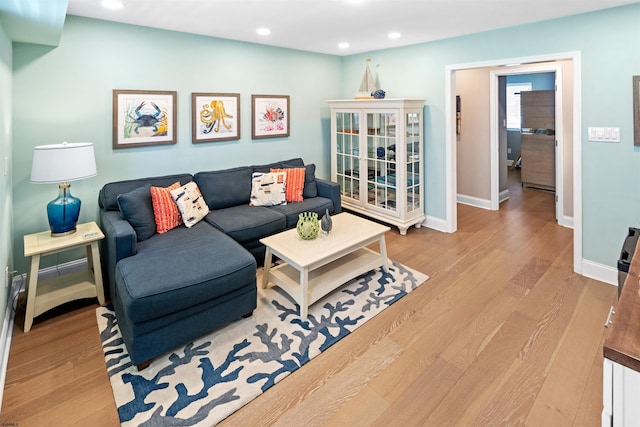 living room featuring recessed lighting, wood finished floors, and baseboards