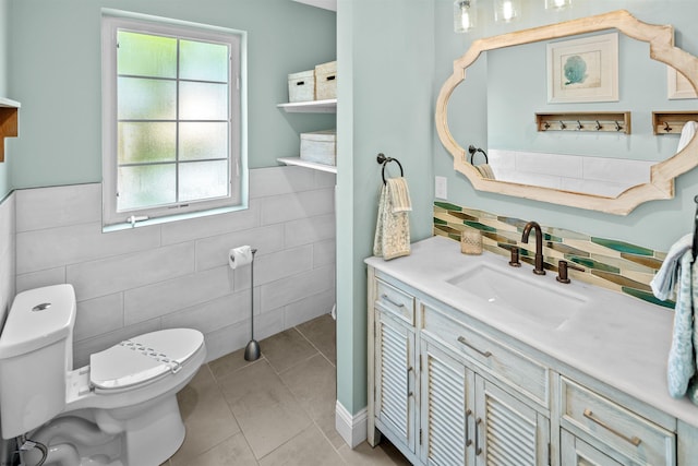 bathroom with wainscoting, vanity, toilet, and tile patterned floors