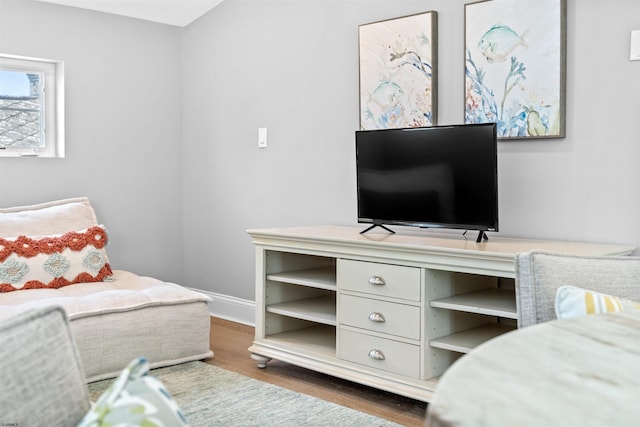 bedroom with baseboards and wood finished floors