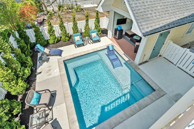 view of swimming pool featuring a patio area, a fenced backyard, and a fenced in pool