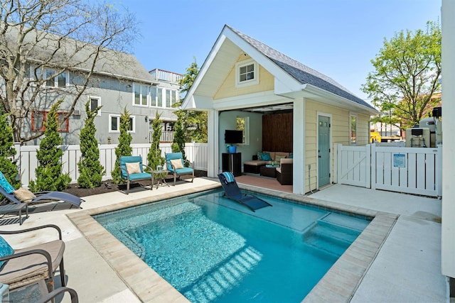 rear view of property featuring an outbuilding, a patio, and fence