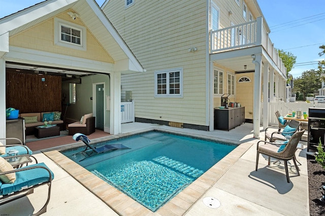 rear view of property featuring a balcony, an outdoor hangout area, a fenced in pool, and a patio