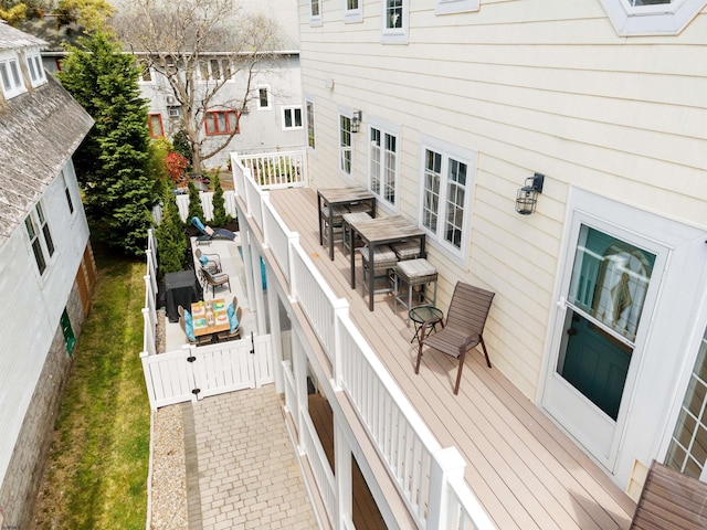 wooden terrace featuring outdoor dining area and fence