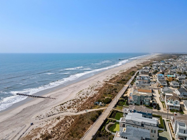 drone / aerial view featuring a water view and a view of the beach