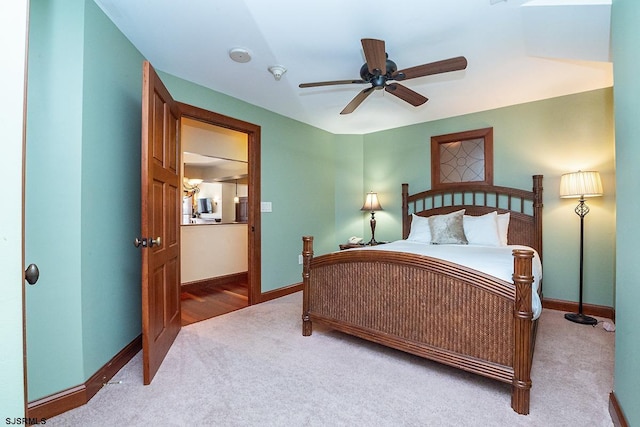 carpeted bedroom featuring ceiling fan and baseboards