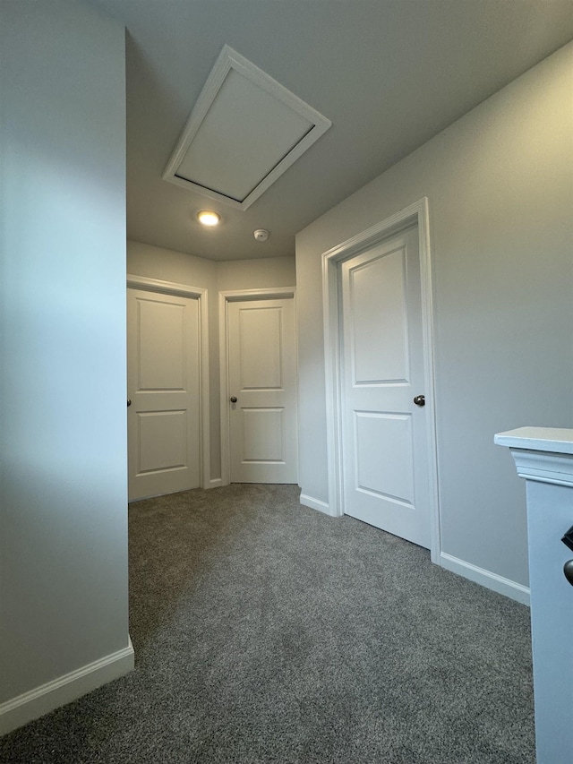 corridor with baseboards and carpet flooring