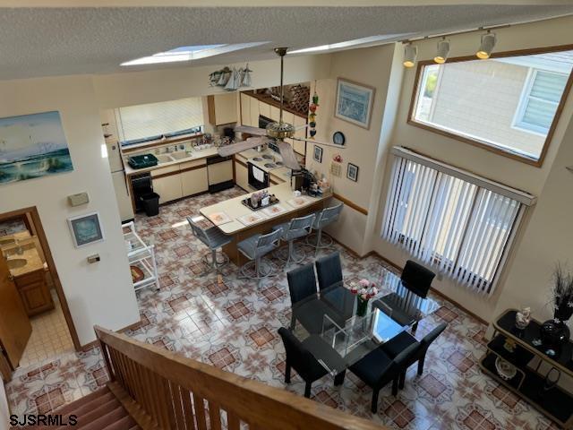 living room with a towering ceiling and a textured ceiling