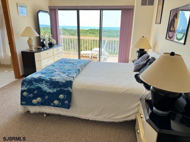 bedroom featuring access to exterior, carpet, and visible vents