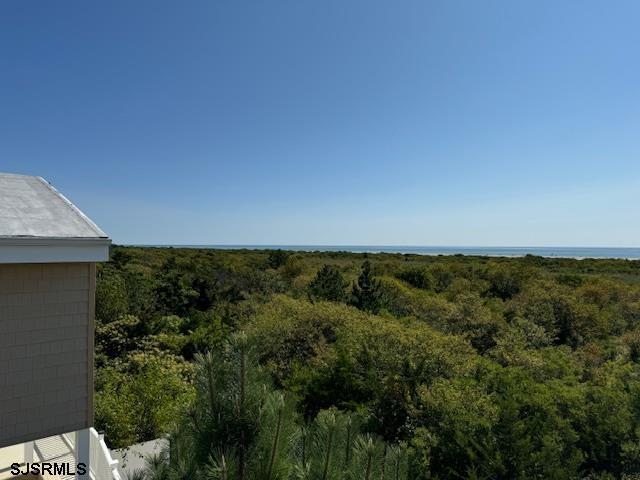 exterior space featuring a forest view