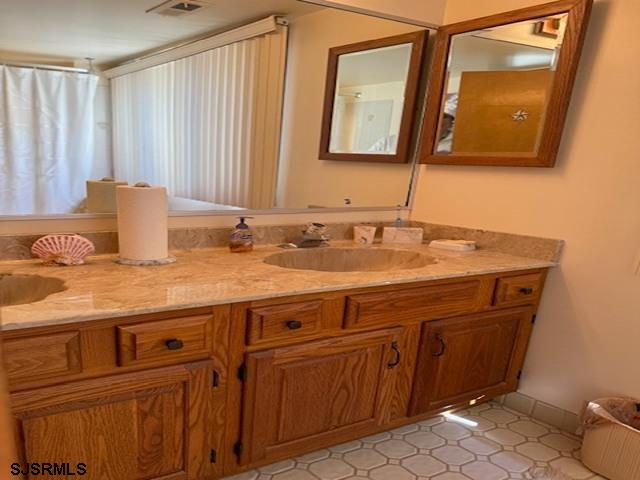 bathroom with vanity and visible vents