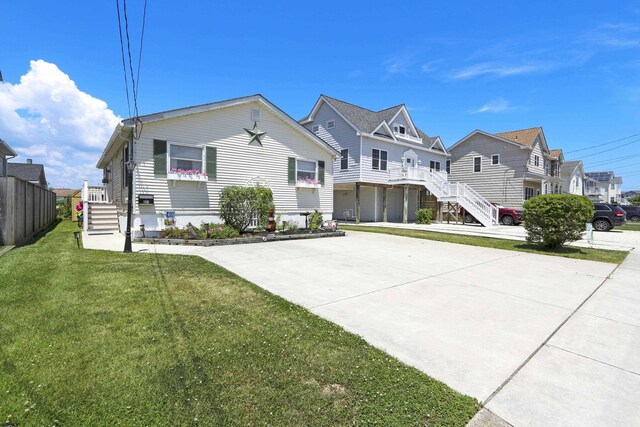 view of front of home with a garage and a front lawn