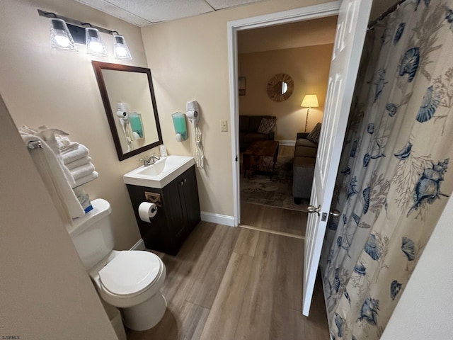 bathroom with hardwood / wood-style floors, vanity, and toilet