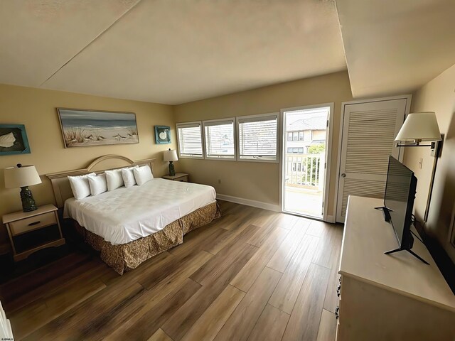 bedroom featuring access to outside and wood-type flooring