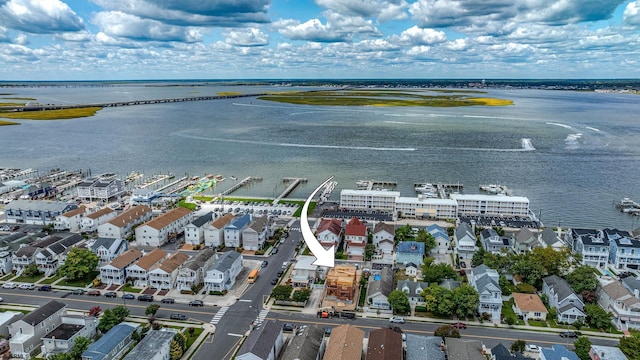 drone / aerial view with a water view and a residential view