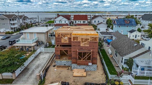 drone / aerial view with a residential view and a water view