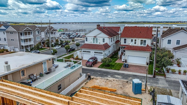 bird's eye view with a water view and a residential view