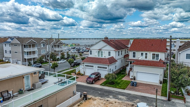 bird's eye view featuring a residential view and a water view